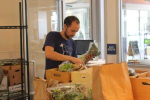 BUSY: Santa Monica Merchant founder Giles Donavan packs a crate for a customer. (Photo by Michael Ryan)