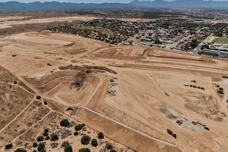 An aerial view of a giant dirt lot under construction that will soon be a community development.