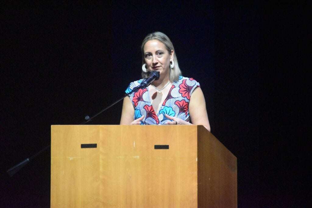 A female Mayor in Santa Monica, California delivers a speech on stage.