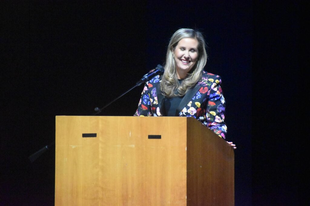 A female Mayor Pro Tem in Santa Monica, California delivers a speech on stage.